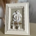 Keraminis angelas rėmelyje